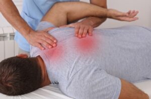 Man suffering from back pain, illustrating the need for orthotics in Pikesville, MD