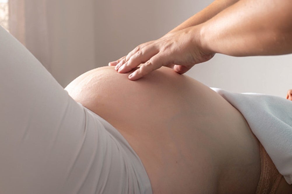 A pregnent women is getting a chiropractic care in Pikesville, MD